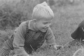 Chłopiec siedzący na trawie